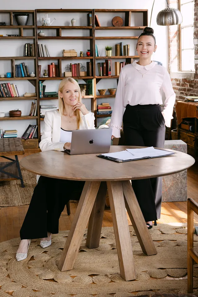US Quest founders working together at a table with case materials